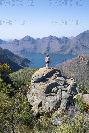 Hiker enjoying panorama, Blyde River Canyon with summit Three Rondawels, view of canyon with river