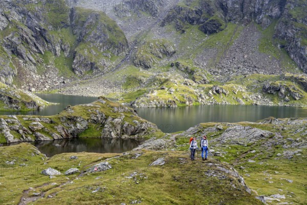 Two female mountaineers in a cloudy mountain landscape, Kreuzsee mountain lake, Wiener Höhenweg,