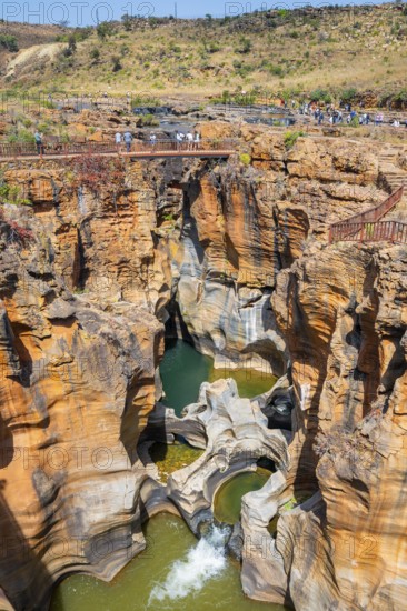 Eroded rock formations, canyon with steep orange-coloured rock cliffs with the Blyde River,