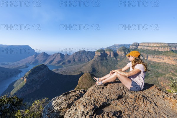 Hiker enjoying panorama, Blyde River Canyon with summit Three Rondawels, view of canyon with river