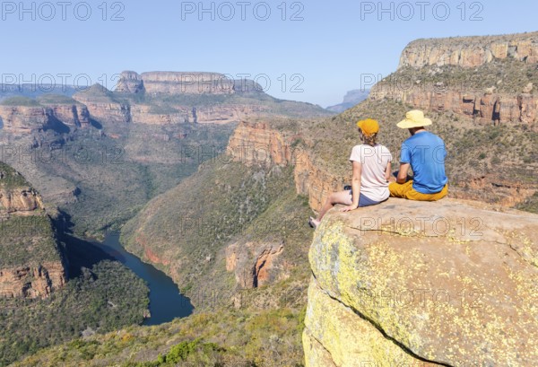 Two hikers enjoying panorama, Blyde River Canyon with Three Rondawels peak, view of gorge with