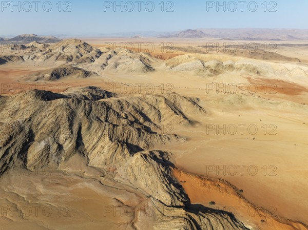 Arid plains, sand dunes and bare mountain ridges in the Tsondab Valley in the Namib Desert. Aerial