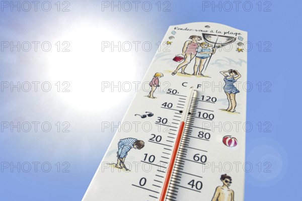 Worm's-eye view of thermometer measures extremely hot temperature of 34 degrees Celsius, 34 °C, 93.