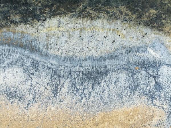 Abstract saline patterns at the edge of the Walvis Bay salt works. Aerial view. Drone shot. Namibia