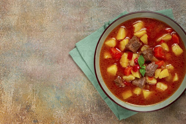 Meat goulash, with potatoes and carrots, sweet pepper, traditional Hungarian soup, homemade, no