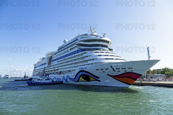 Cruise ship AIDA nova is pushed against the quay wall by tugboats, Warnow, Warnemünde, Rostock,