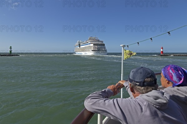 Cruise ship AIDA nova leaving, lighthouse, spectators, escort cruise, Warnow estuary, Warnemünde,