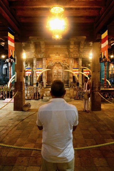 Pilgrims praying in front of the Holy Shrine, Temple of the sacred Tooth Relic or Sri Dalada