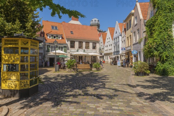 Renovated Schnoor district with small shops, square with historic public telephone, telephone box,