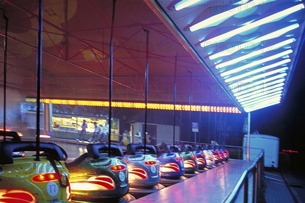 Illuminated bumper cars at night, New Jersey, USA