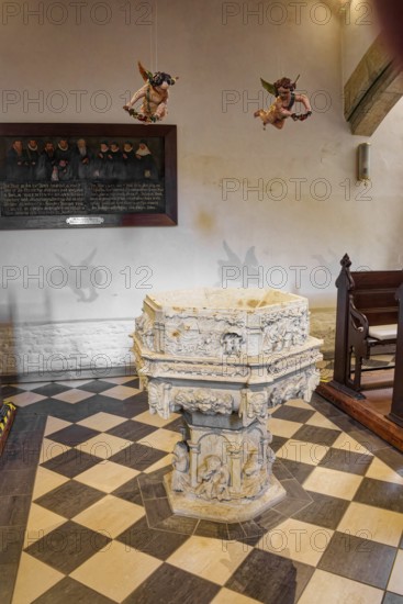 Baptismal font, sandstone baptismal font from the Renaissance period from 1603, created by H.