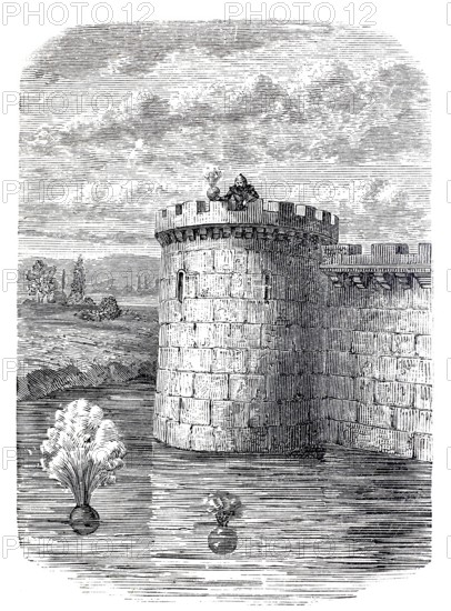 Detonating bullets, precursor of the depth charge, here being tested from a castle tower in a moat,
