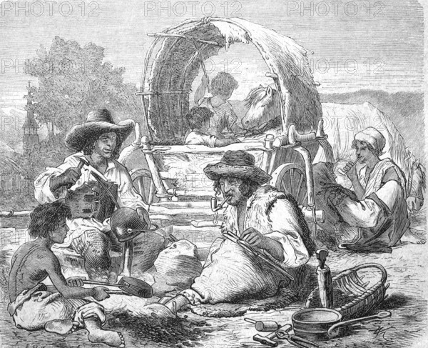 Travelling gypsies at work, here as metalworkers in front of their wagon, Hungary, Historical,