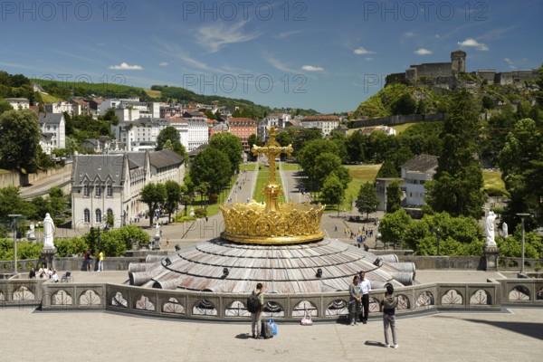 The gilded crown of the Basilica of the Rosary, Rosary Square and ChÃ¢teau fort de Lourdes fortress