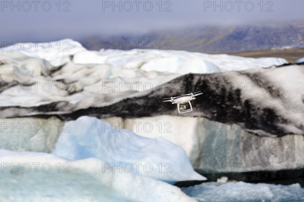 Camera drone flies over icebergs, JökulsÃ¡rlÃ³n glacier lagoon, Jökulsarlon, glacial lake,