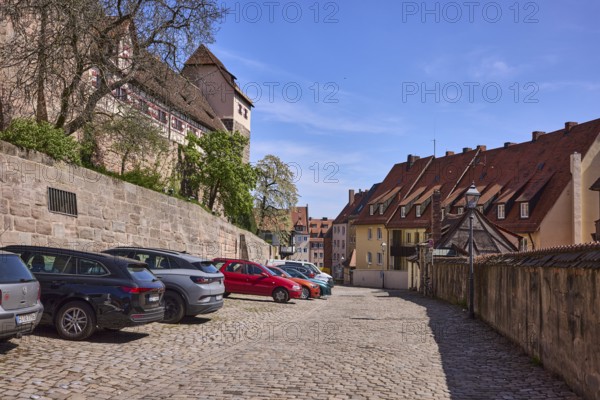 Old town, street, cobblestone pavement, residential building, castle, lantern, parking boxes,
