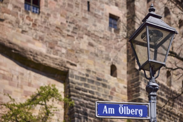 Street sign, street name Am Ã–lberg, lantern, castle wall, depth of field, Nuremberg, Middle