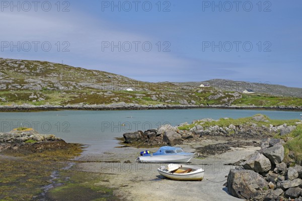 Two boats on a rocky shore in a quiet bay under a clear sky in front of hills, Idyll, Outer
