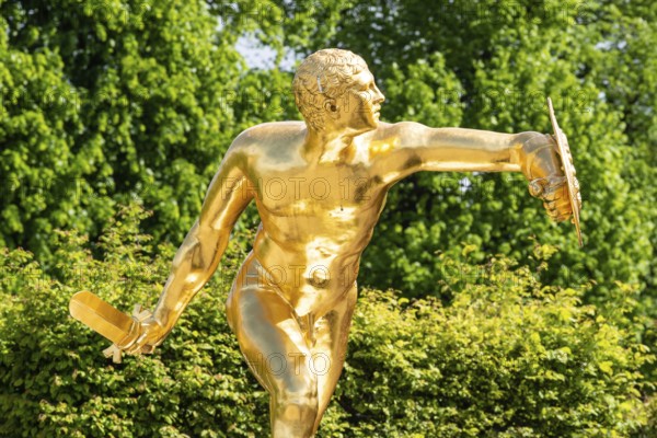 Golden sculpture, warrior with shield and sword, Herrenhausen Gardens, Baroque garden at castle