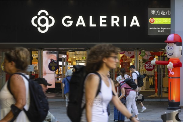 Galeria Kaufhof. Logo and entrance of the department stores' with people in Stuttgart,