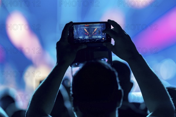 A concertgoer films Lionel Richie with his smartphone on the Say Hello To The Hits 2025 Tour at the