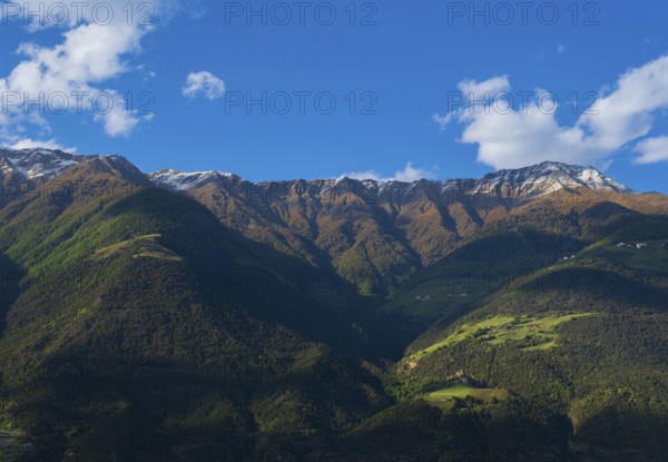 View of the Sonnenberg with Annenberg Castle and the farms above in the evening light, Dolomites,