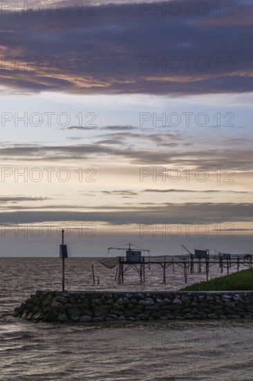 Sunset over Fishing huts over Gironde Estuary, Braud-et-Saint-Louis, France