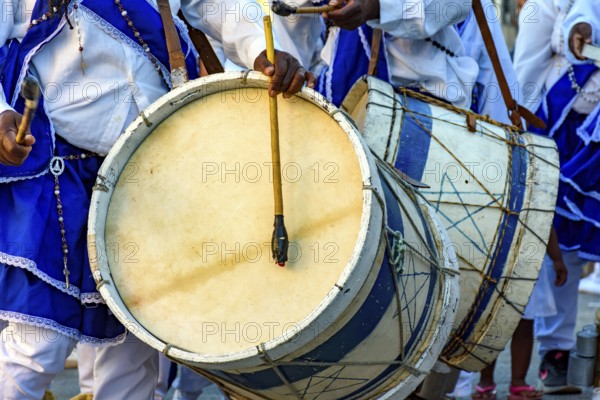 Musicians with their rustic wooden drums and colorful clothes during the religious festival of