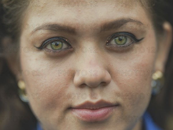Close up of Latin American girl face looking and smiling at the camera. Portrait of attractive