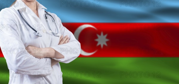 Doctor with crossed arms on Azerbaijan flag. Azerbaijan health and care concept. Female doctor on