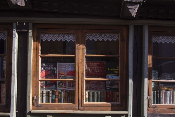 Decorated shop window with historical railway books and nostalgic flair, antiquarian bookshop,