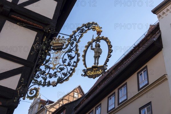 Traditional cantilever sign Zum Roland on a half-timbered house, Quedlinburg, Saxony-Anhalt,