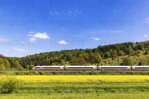 InterCityExpress ICE en route on the Swabian Alb near Lonsee. Landscape on the railway's