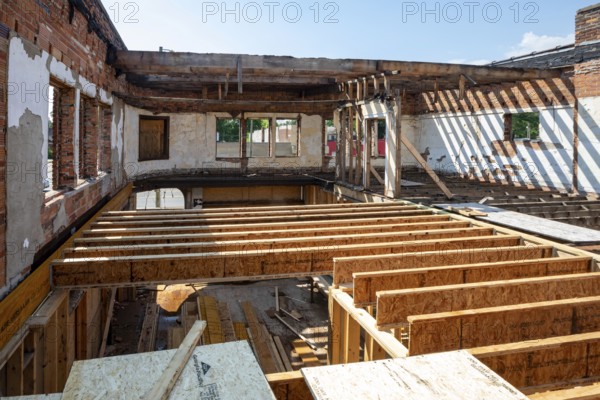 Detroit, Michigan - Workers rehab a long-vacant and crumbling commercial building in the