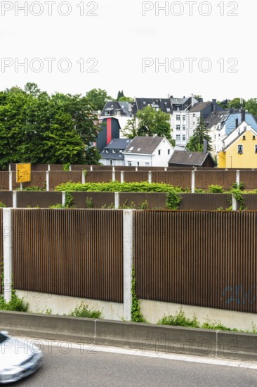 A row of noise barriers in front of a residential area at the Sonnborn junction in Wuppertal,