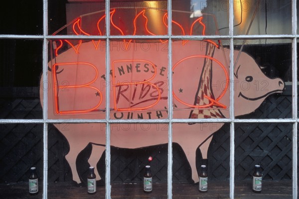 Illuminated advertising for BBQ, barbecue, grill, with a pig figure in a shop window, Manhattan,