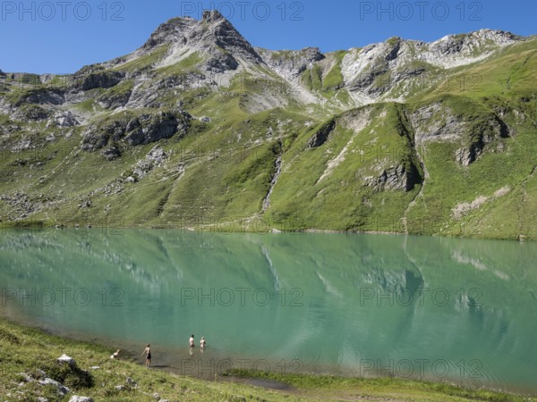 HIker at lake Engeratsgundsee, mountain range between Oberstdorf and Bad Hindelang, Allgaeu,