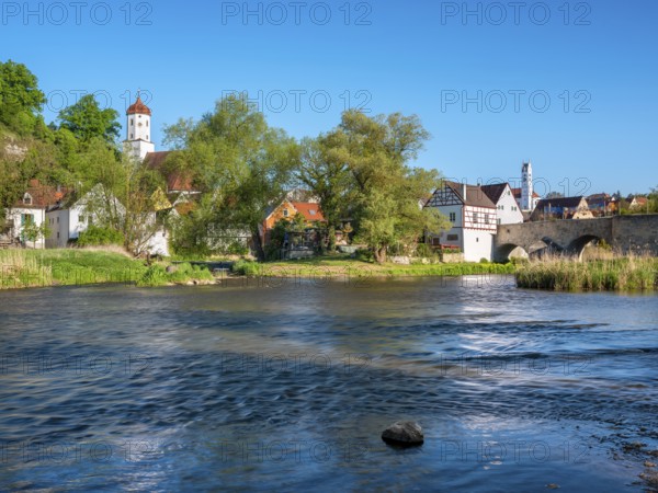 View over the river Wörnitz to the old town with the Stone Bridge and the churches of St Barbara