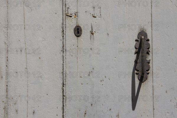 Metal fittings on an old wooden door, Tuscany, Italy