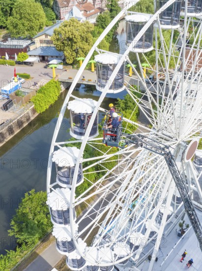 Aerial view of Ferris wheel and emergency services, fire brigade exercise for gondola rescue,