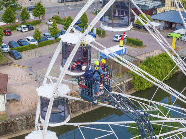 Fire brigade uses platform for rescue on Ferris wheel, Fire brigade exercise for gondola rescue,