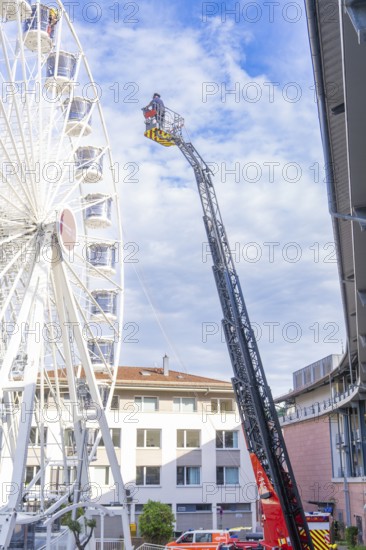 Fire brigade ladder next to a building front with operating platform in use, fire brigade exercise