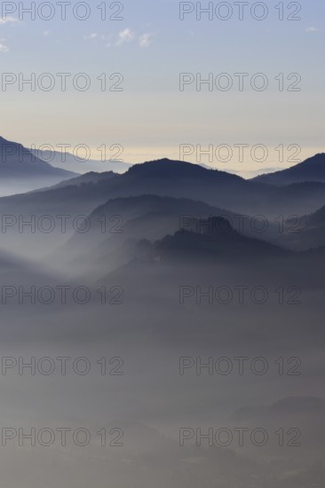 Mountain silhouettes... Alpine peaks and mountain ranges in the Bavarian Alps, light fog rises from