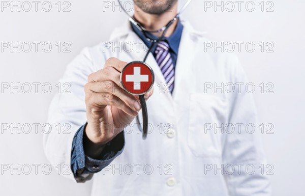 Switzerland healthcare system, doctor holding stethoscope. Switzerland health and medical insurance