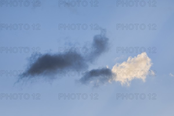 Black and white clouds in the blue evening sky