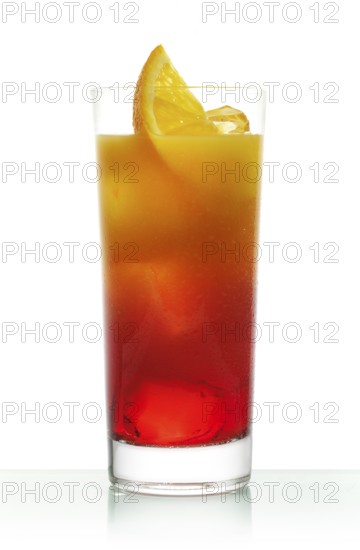 Campari orange in a long drink glass on ice with orange slices as garnish against a white