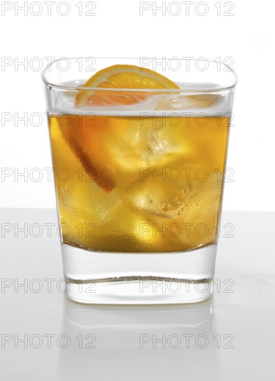 Cocktail in a tumbler on ice with half a slice of orange as garnish against a white background,