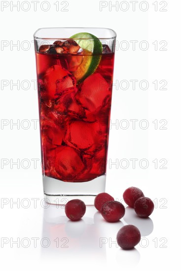 Cocktail in a long drink glass on ice with a slice of lime and cranberries as garnish against a