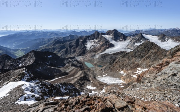 View of mountain basin with blue glacier lakes, Ãœbeltalferner glacier and Königshofspitz summit in