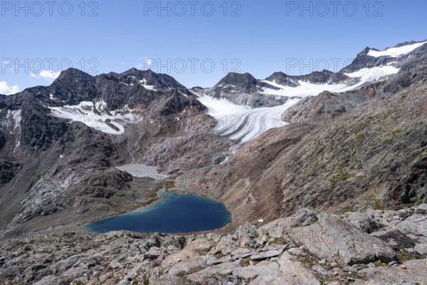 Blue glacial lake in a rocky mountain landscape, behind Königshofspitz and Ãœbeltalferner glacier,